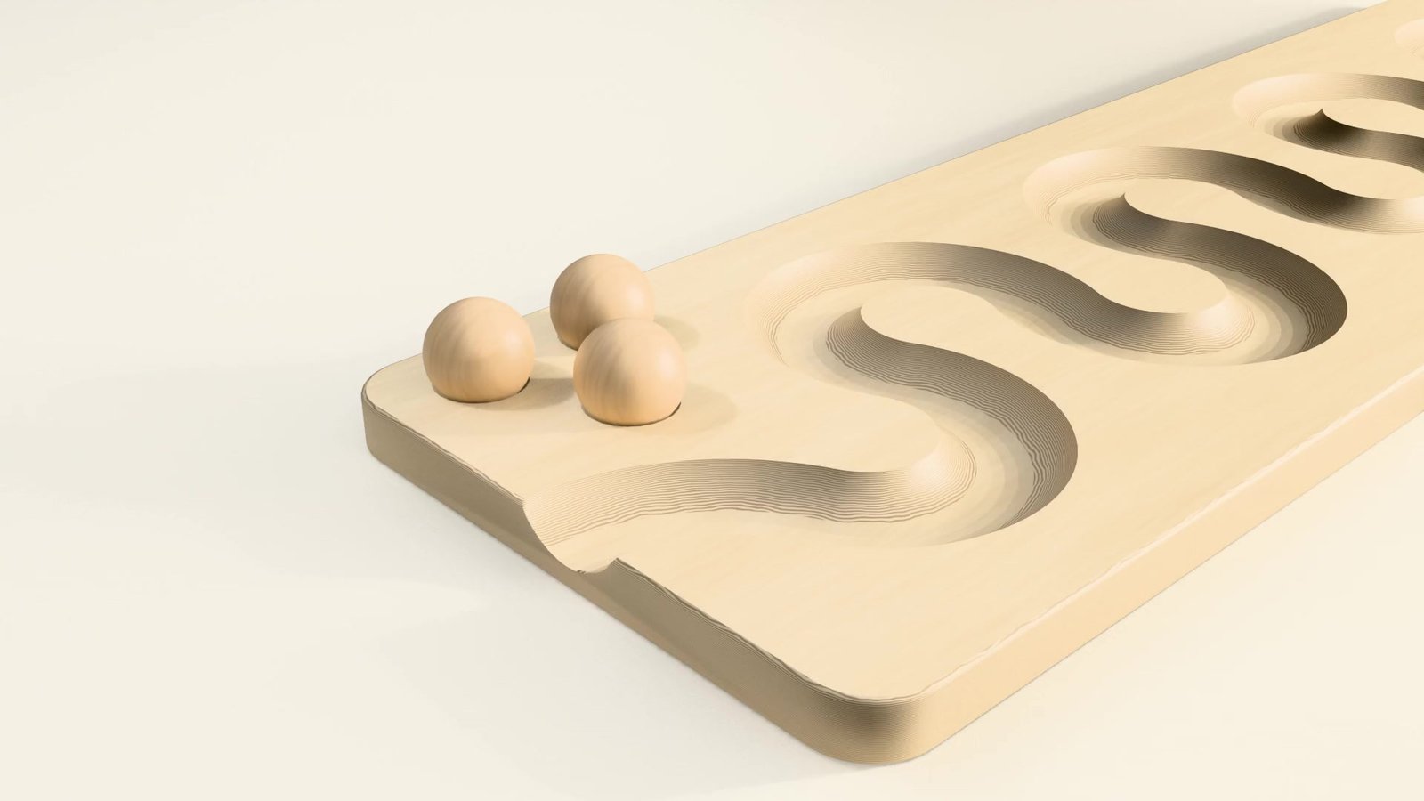 Three wooden balls resting on a winding wooden ball run board