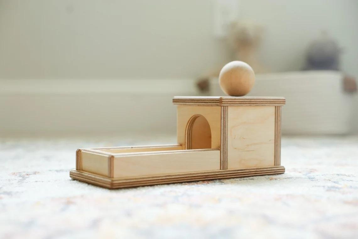 Wooden object permanence box with a ball and tray